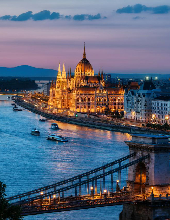 A panoramic view of the illuminated Chain Bridge and Hungarian Parliament Building